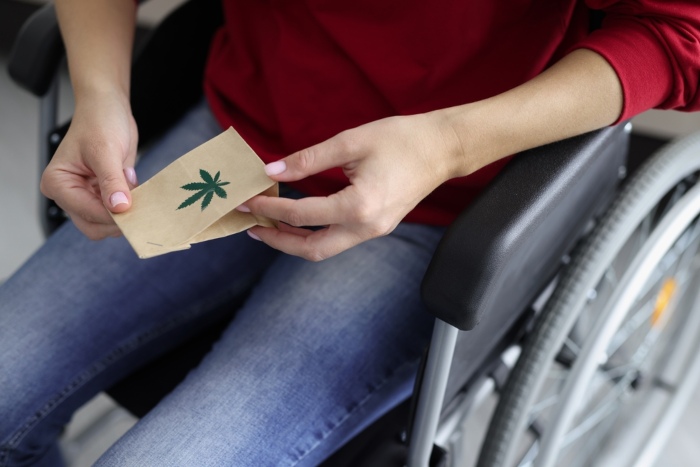 wheelchair person with paper bag cannabis